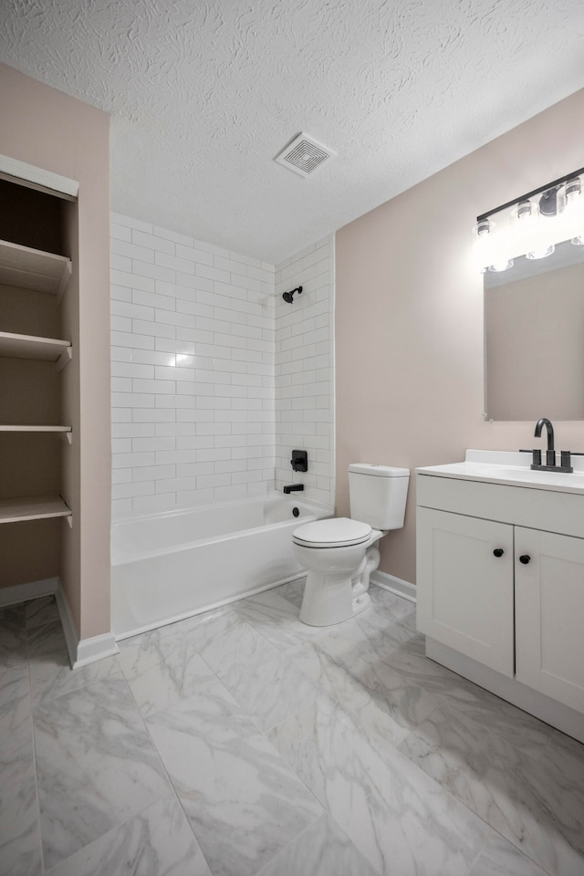 full bathroom featuring a textured ceiling, vanity, toilet, and tiled shower / bath