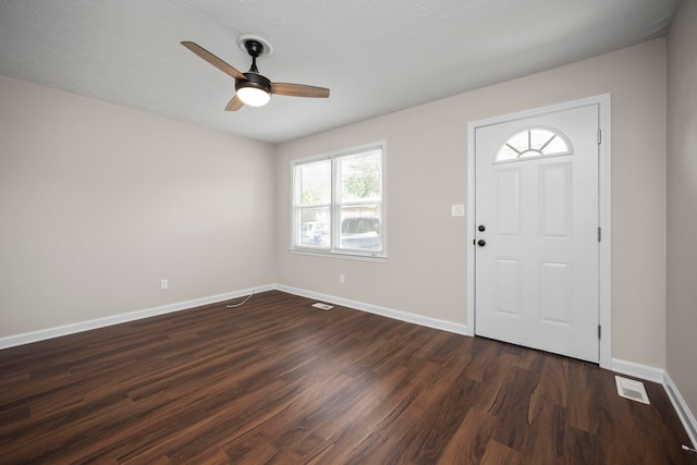 entryway featuring ceiling fan, dark hardwood / wood-style flooring, and a textured ceiling