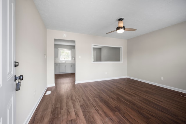 interior space featuring ceiling fan, wood-type flooring, and sink