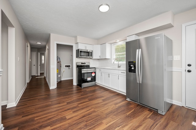 kitchen featuring sink, stainless steel appliances, white cabinets, and dark hardwood / wood-style floors