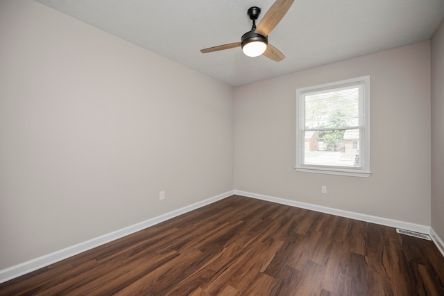 spare room featuring ceiling fan and dark hardwood / wood-style flooring