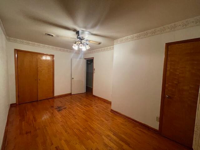 unfurnished bedroom featuring ceiling fan and hardwood / wood-style floors