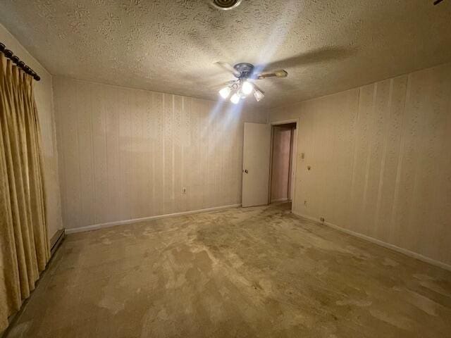 spare room with ceiling fan and a textured ceiling