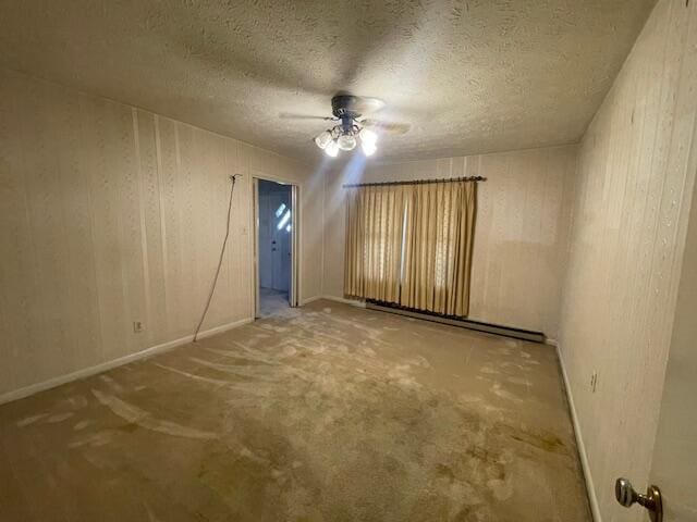 unfurnished room featuring a textured ceiling, a baseboard radiator, and ceiling fan