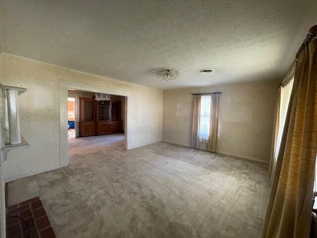 spare room with carpet flooring and a textured ceiling