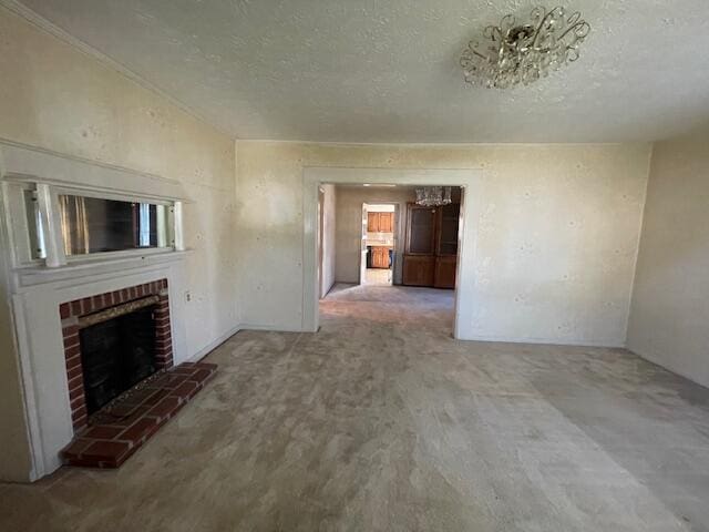 unfurnished living room with a textured ceiling, carpet flooring, and a fireplace