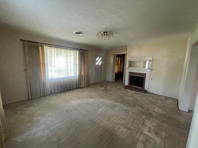 unfurnished living room with a fireplace and a textured ceiling