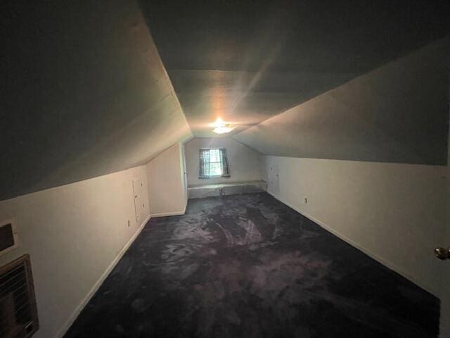 bonus room featuring carpet flooring and vaulted ceiling