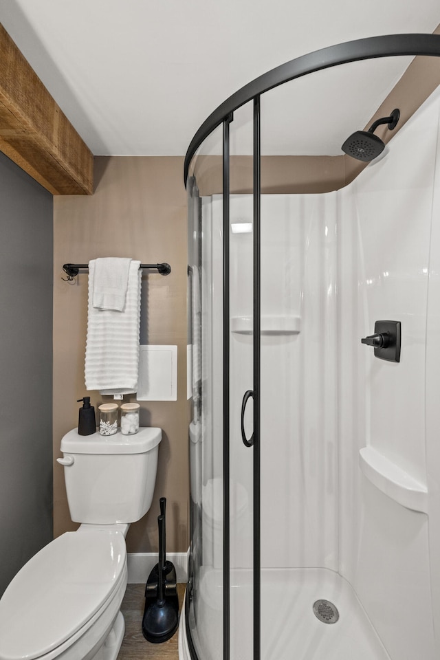 bathroom featuring hardwood / wood-style floors, toilet, and walk in shower