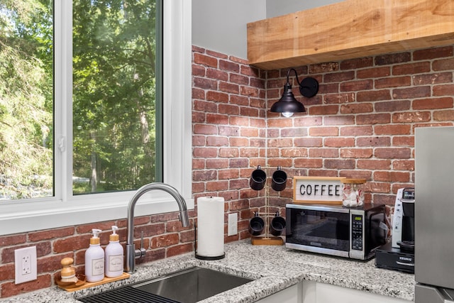 1545 Beaver Lake Rd, Lawrenceburg, KY 40342 - room details with light stone counters, a sink, stainless steel microwave, and tasteful backsplash
