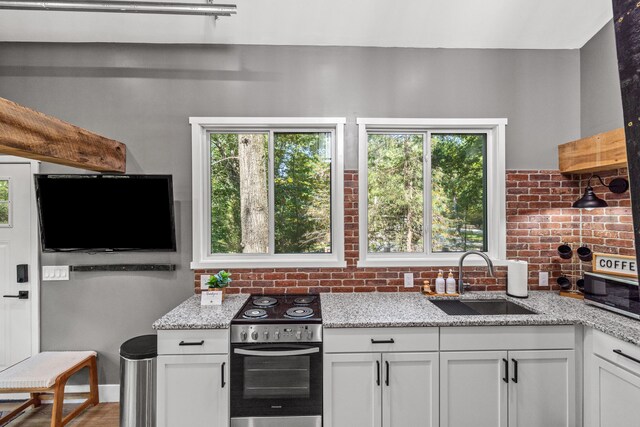 1545 Beaver Lake Rd, Lawrenceburg, KY 40342 - kitchen featuring a sink, white cabinetry, backsplash, and stainless steel appliances