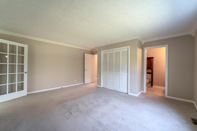 unfurnished bedroom with a textured ceiling, light colored carpet, and a closet