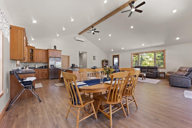 dining area featuring light wood-style flooring, high vaulted ceiling, ceiling fan, and beamed ceiling