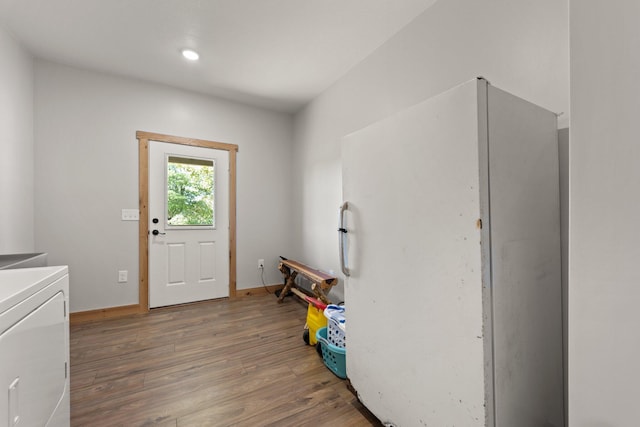 interior space featuring dark wood finished floors, washer / dryer, and baseboards