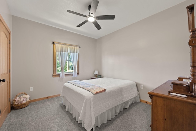 bedroom featuring light carpet, baseboards, and a ceiling fan