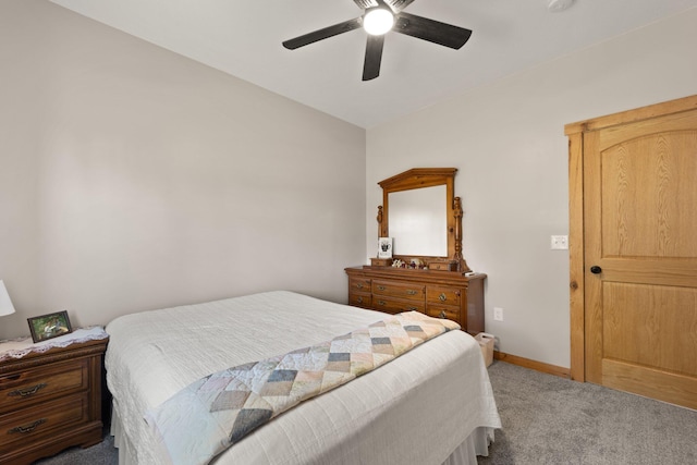 carpeted bedroom featuring lofted ceiling, baseboards, and a ceiling fan