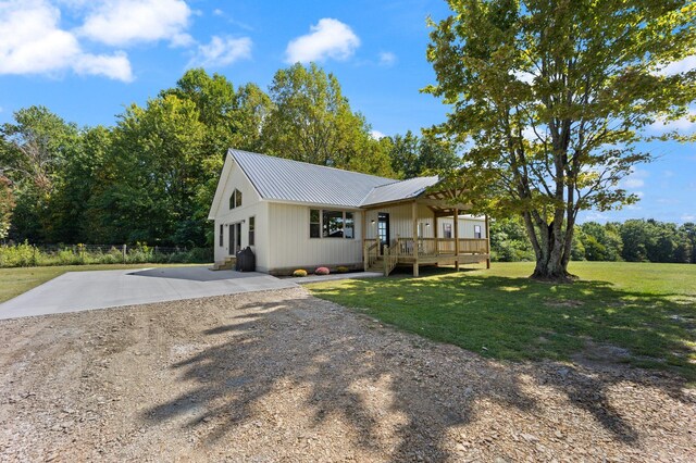 back of property with a yard and a wooden deck