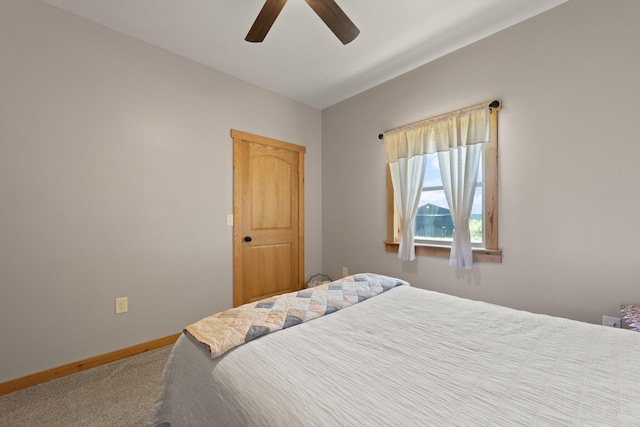 carpeted bedroom featuring a ceiling fan and baseboards