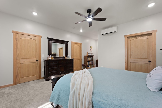 carpeted bedroom with a wall unit AC, ceiling fan, baseboards, and recessed lighting