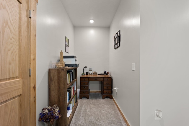 carpeted home office featuring baseboards