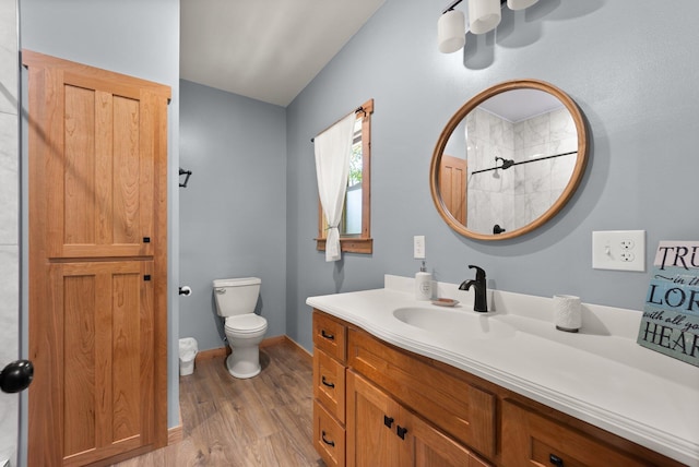 full bath with toilet, vanity, baseboards, and wood finished floors