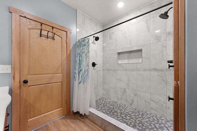 bathroom featuring a stall shower and wood finished floors