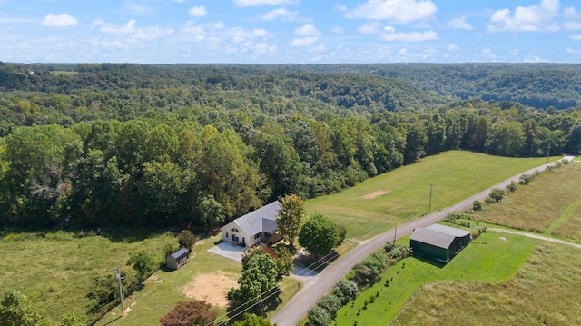 bird's eye view with a rural view and a wooded view