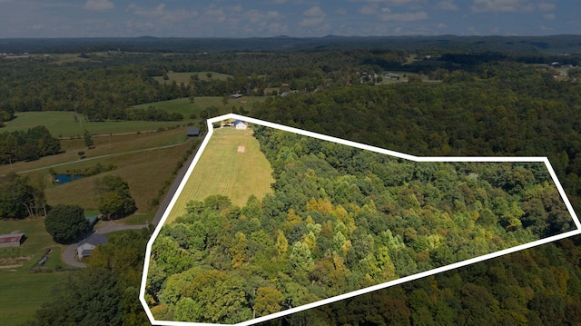 drone / aerial view featuring a forest view