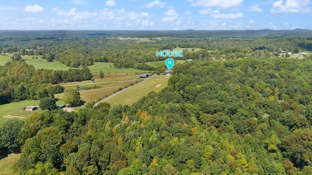 drone / aerial view with a wooded view