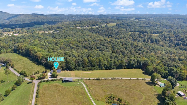 birds eye view of property with a forest view