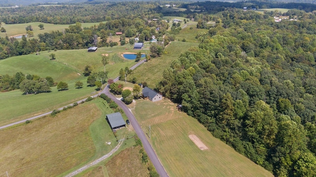 drone / aerial view featuring a rural view and a wooded view