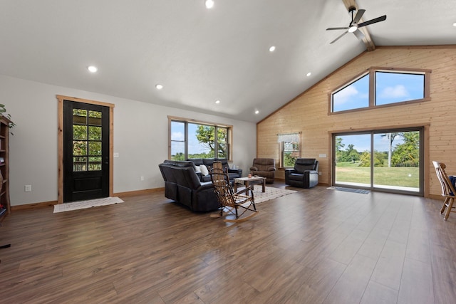 living area featuring baseboards, dark wood-style floors, high vaulted ceiling, beam ceiling, and recessed lighting