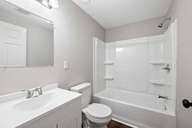 full bathroom featuring hardwood / wood-style flooring, toilet, shower / bath combination, vanity, and a textured ceiling