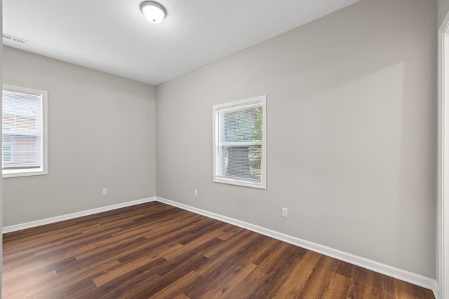 empty room with dark wood-type flooring