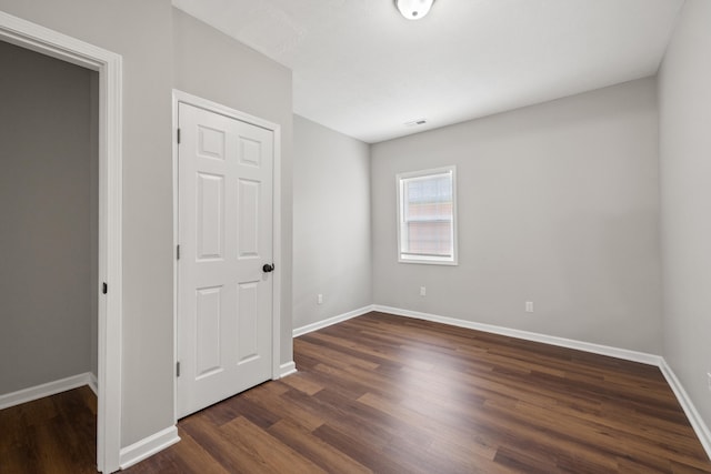 unfurnished bedroom featuring dark hardwood / wood-style floors