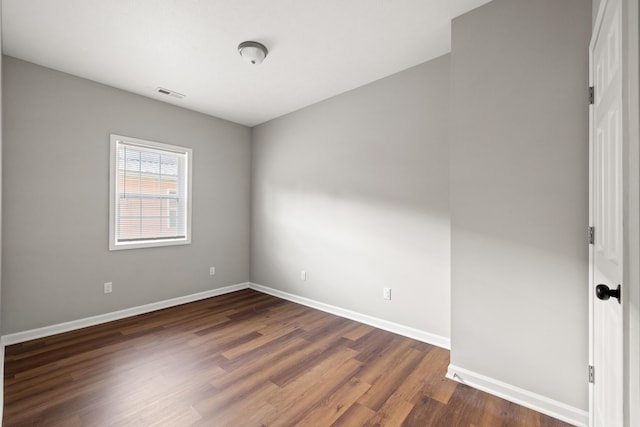 unfurnished room with dark hardwood / wood-style floors