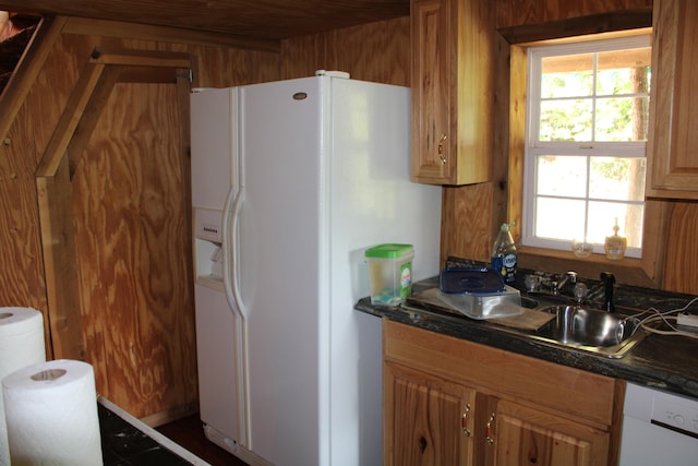 kitchen featuring white appliances, sink, and a healthy amount of sunlight