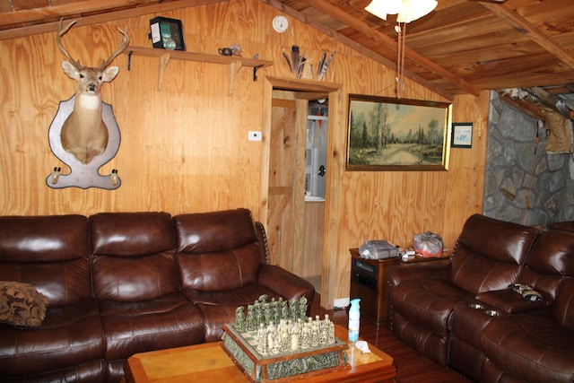 living room with wood-type flooring, wooden walls, lofted ceiling with beams, and wooden ceiling