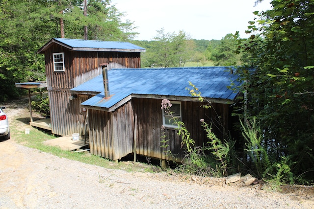 view of property exterior with a storage unit