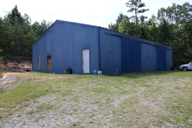 view of outbuilding featuring a lawn