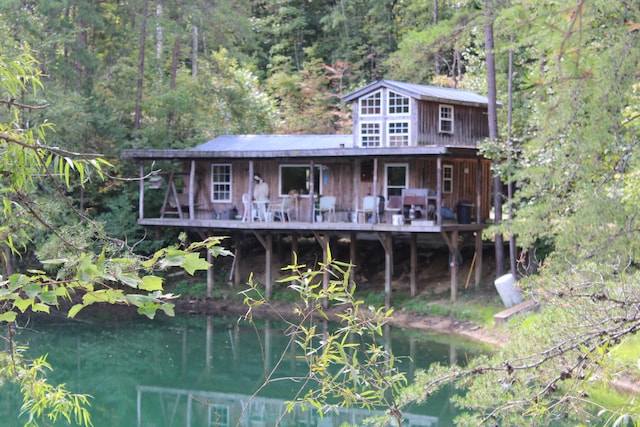 back of property with a water view