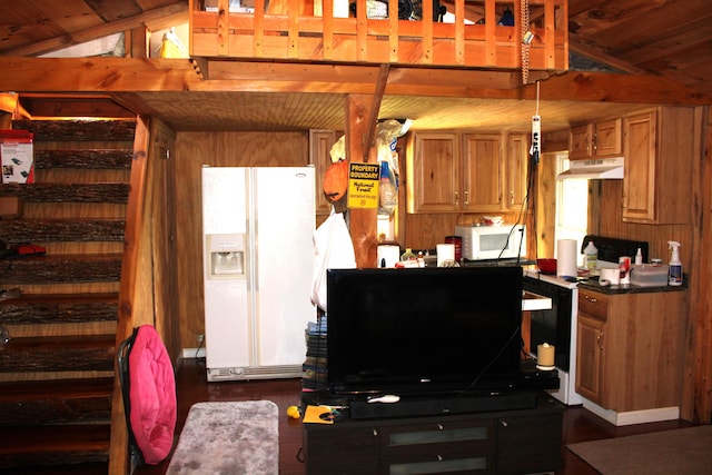 kitchen featuring white appliances, lofted ceiling, decorative light fixtures, and dark wood-type flooring