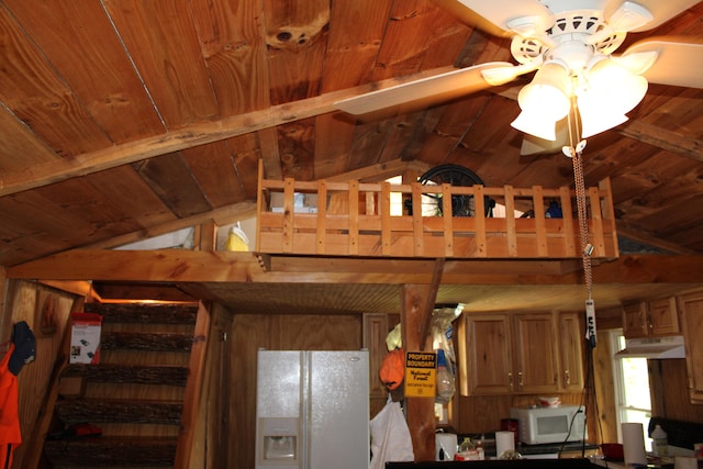 interior space with lofted ceiling with beams, wood walls, ceiling fan, and wood ceiling