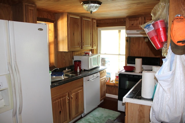 kitchen with white appliances, wood walls, range hood, sink, and wooden ceiling