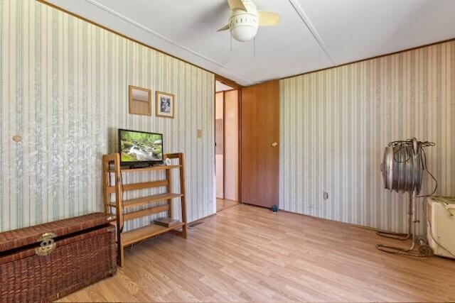 interior space with light hardwood / wood-style flooring and ceiling fan