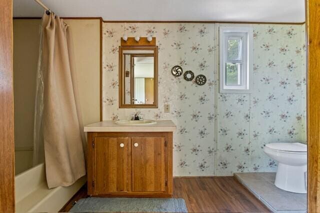 full bathroom featuring vanity, toilet, wood-type flooring, and shower / bath combo