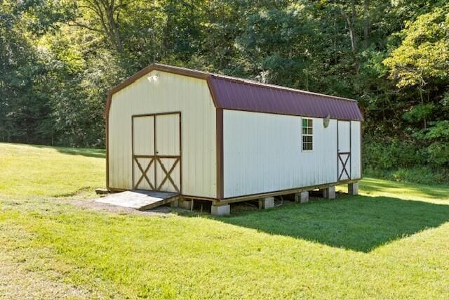 view of outbuilding with a lawn