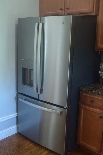 kitchen featuring dark wood-type flooring and stainless steel refrigerator with ice dispenser