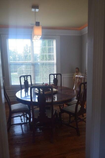 dining room with a healthy amount of sunlight and wood-type flooring