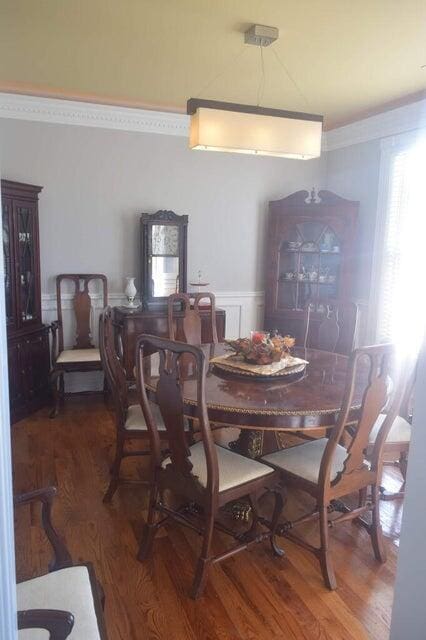 dining area with dark hardwood / wood-style floors and ornamental molding